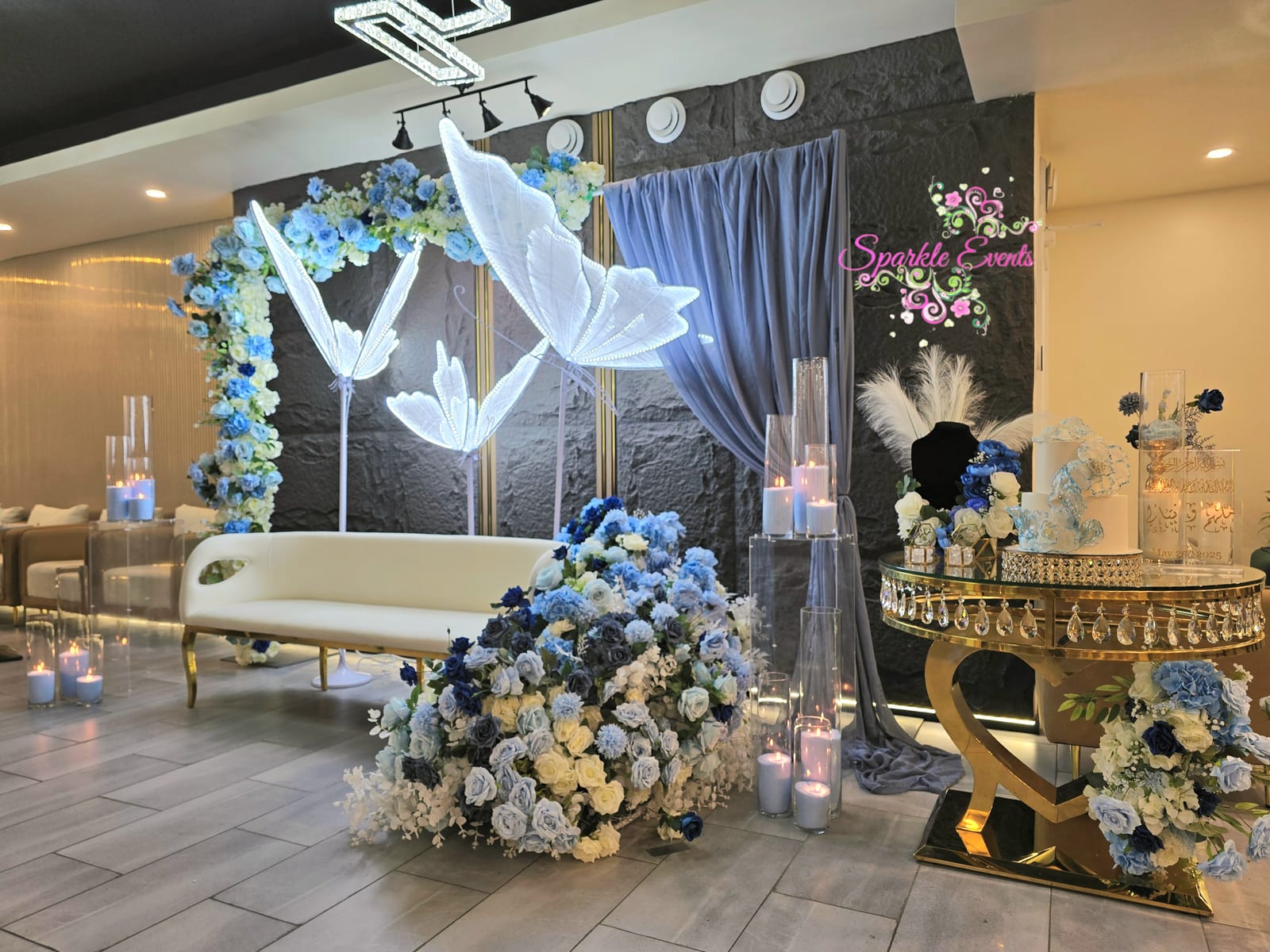 Lit Butterfly Wings And Blue Floral Arch