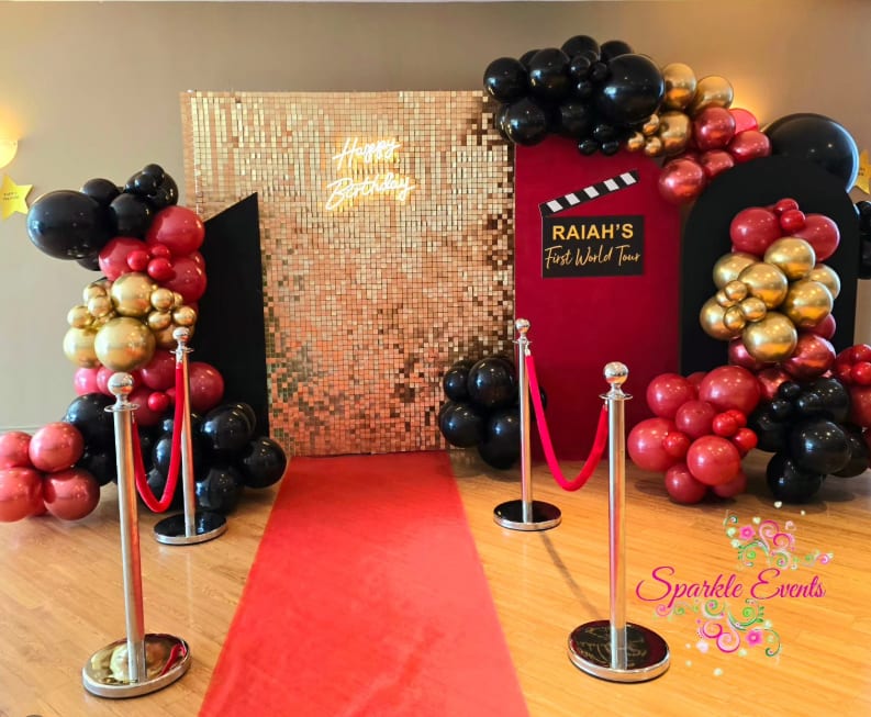 A Hollywood-themed first birthday installation by Sparkle Events in Ottawa, with a balloon garland and a styled dessert table